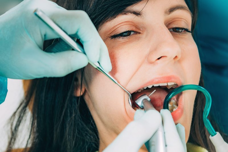Dentist Working with Young Female Patient